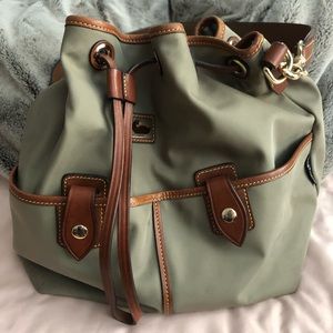 Dooney and Bourke green drawstring bag w/brown leather and gold hardware